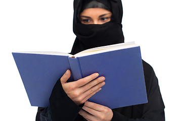 Image showing muslim woman in hijab reading book over white