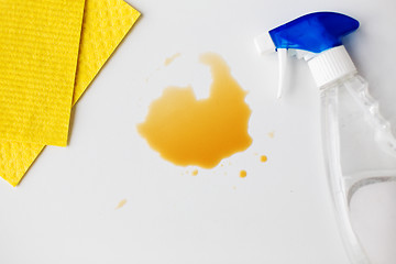 Image showing cleaning rag, detergent spray and spilled stain