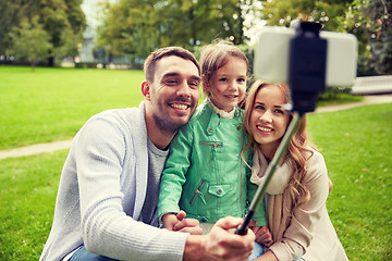 Image showing happy family taking selfie by smartphone outdoors