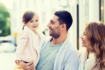 Image showing happy family with child and shopping bags in city