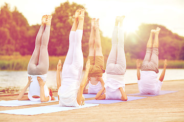 Image showing group of people making yoga exercises outdoors