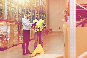 Image showing worker and businessmen with clipboard at warehouse