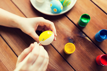 Image showing close up of woman hands coloring easter eggs