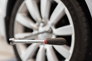 Image showing screwdriver and car wheel tire