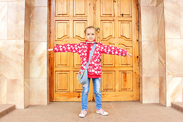 Image showing Schoolgirl before big wooden door