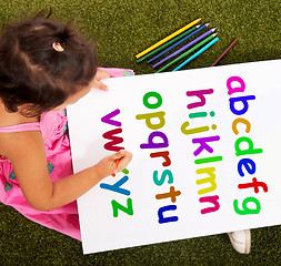 Image showing Girl Writing Alphabet Shows Kid Learning