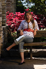 Image showing Prety teenage Girl Sitting on Bench