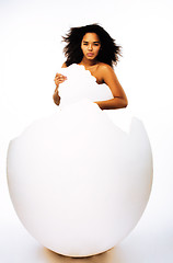 Image showing young pretty african american woman in big cracked egg isolated on white background, fashion people concept