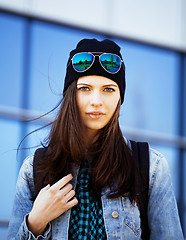 Image showing young pretty girl near business building walking