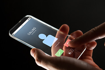 Image showing close up of hand with incoming call on smartphone