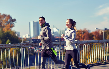 Image showing happy couple running outdoors