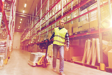 Image showing man carrying loader with goods at warehouse