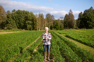 Image showing happy senior woman at farm