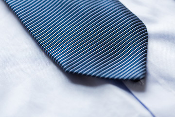 Image showing close up of shirt and blue patterned tie