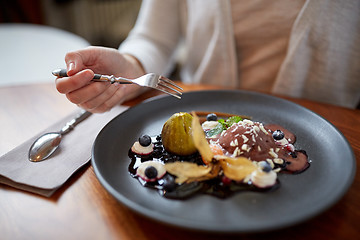 Image showing woman eating ice cream dessert at restaurant