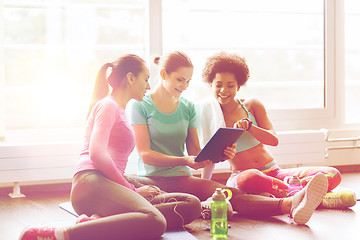 Image showing group of happy women with tablet pc in gym