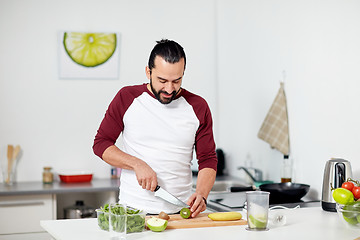 Image showing man with blender and fruit cooking at home kitchen