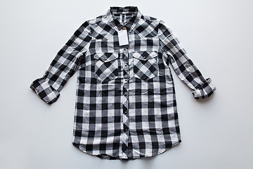 Image showing checkered shirt with price tag on white background