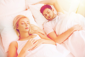 Image showing happy couple sleeping in bed at home