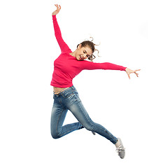 Image showing happy young woman jumping in air or dancing