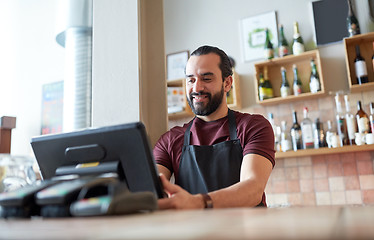 Image showing happy man or waiter at bar cashbox