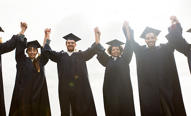 Image showing happy students or bachelors celebrating graduation