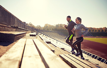 Image showing happy couple running upstairs on stadium