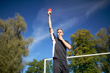 Image showing referee on football field showing yellow card