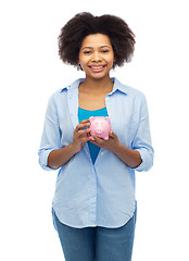 Image showing happy afro american young woman with piggy bank