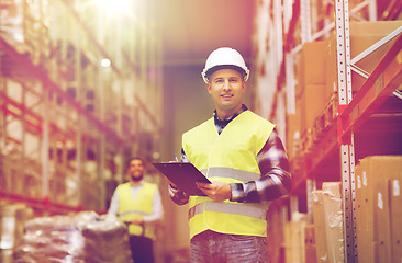 Image showing man with clipboard in safety vest at warehouse