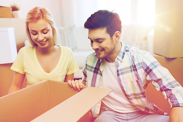 Image showing smiling couple with big boxes moving to new home