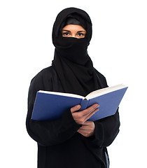 Image showing muslim woman in hijab reading book over white
