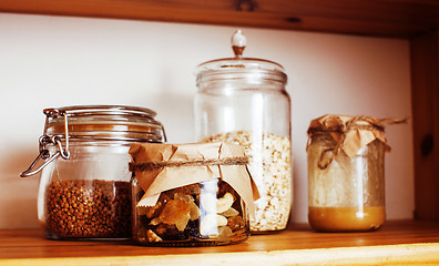 Image showing real comfort wooden kitchen with breakfast ingredients close up 