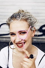 Image showing young pretty party girl smiling covered with glitter tinsel, fas