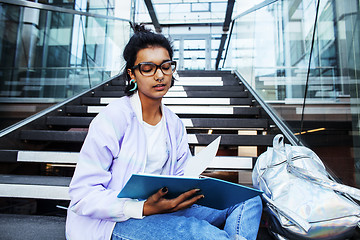 Image showing young cute indian girl at university building sitting on stairs 