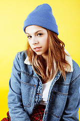 Image showing young pretty teenage girl posing emotional on yellow background, lifestyle people concept