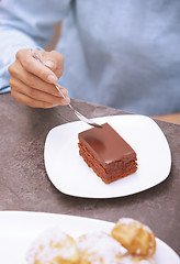 Image showing Woman eating chocolate cake