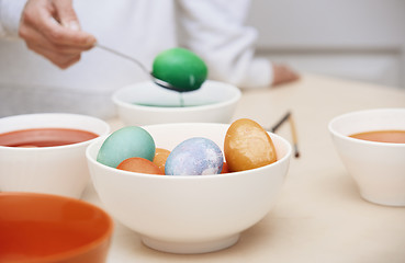 Image showing Woman preparing Easter eggs