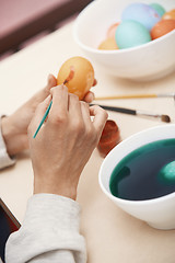 Image showing Woman preparing Easter eggs