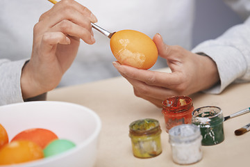 Image showing Woman preparing Easter eggs