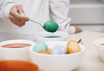 Image showing Woman preparing Easter eggs