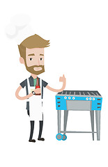 Image showing Man cooking meat on gas barbecue grill.