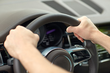 Image showing close up of male hands driving car