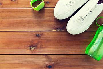 Image showing close up of sneakers, bracelet and water bottle