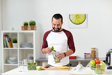 Image showing man with blender cup cooking food at home kitchen