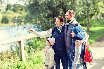 Image showing happy family with backpacks hiking