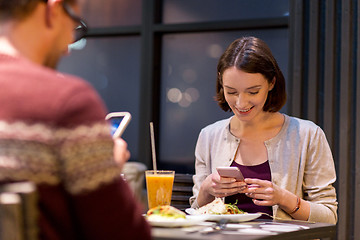 Image showing happy couple having dinner at vegan restaurant