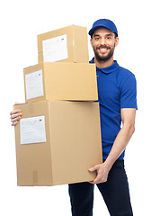 Image showing happy delivery man with parcel boxes