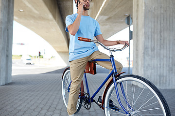 Image showing man with smartphone and fixed gear bike on street