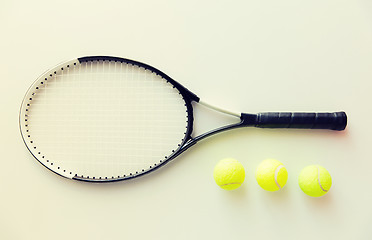 Image showing close up of tennis racket with balls